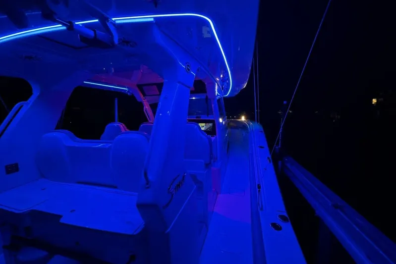  Yacht Photos Pics 2022 Scout 425 LXF boat interior illuminated with blue LED lights at night.