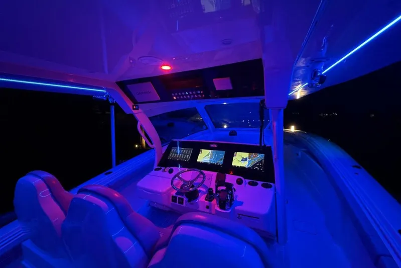  Yacht Photos Pics Illuminated cockpit of 2022 Scout 425 LXF boat with blue LED lighting.
