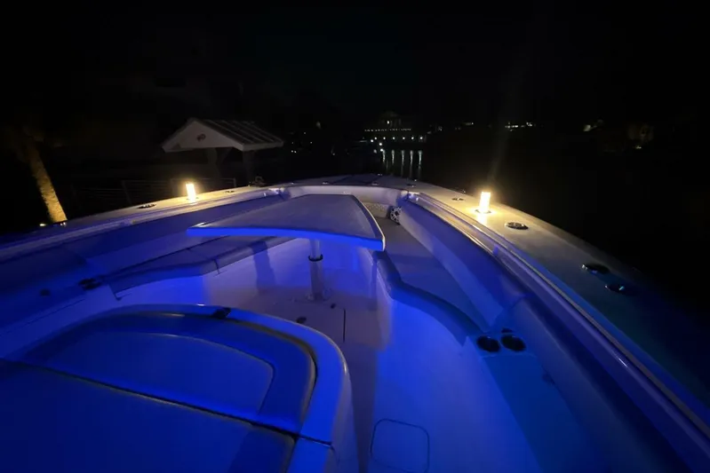  Yacht Photos Pics 2022 Scout 425 LXF boat deck illuminated with blue lights at night.