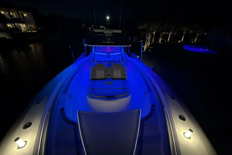  Yacht Photos Pics 2022 Scout 425 LXF boat illuminated with blue lights at night.