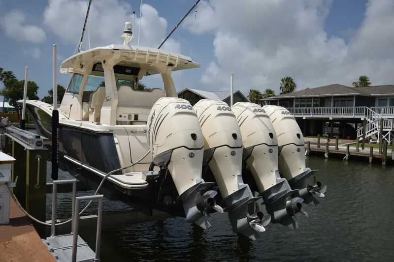  Yacht Photos Pics 2022 Scout 425 LXF boat with four powerful outboard engines docked at marina.
