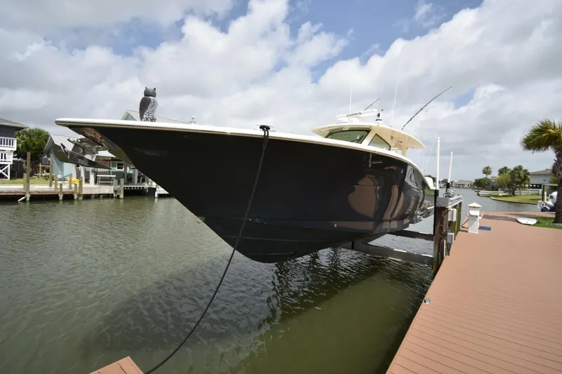  Yacht Photos Pics 2022 Scout 425 LXF boat docked on a sunny day, showcasing sleek design.
