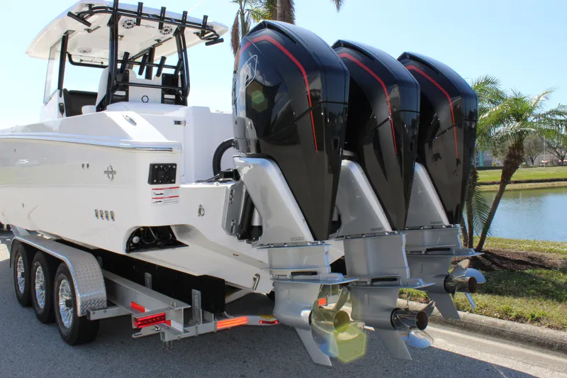  Yacht Photos Pics 2024 Fountain 32 NX boat with triple outboard engines on a trailer.