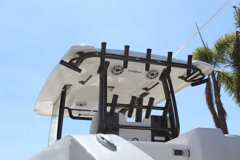  Yacht Photos Pics 2024 Fountain 32 NX boat with T-top and rod holders under clear blue sky.