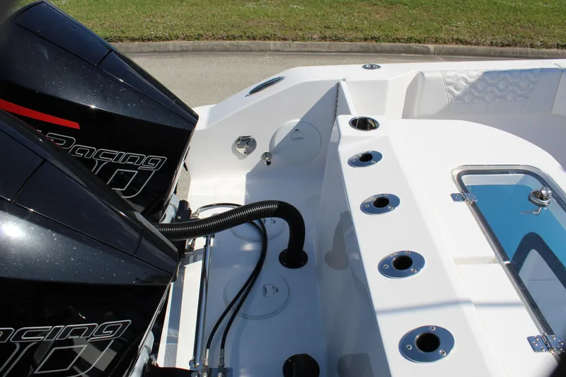  Yacht Photos Pics 2024 Fountain 32 NX boat with dual racing engines and rod holders, showcasing sleek design.