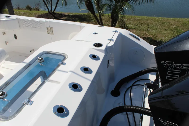  Yacht Photos Pics 2024 Fountain 32 NX boat interior with rod holders and engine view.