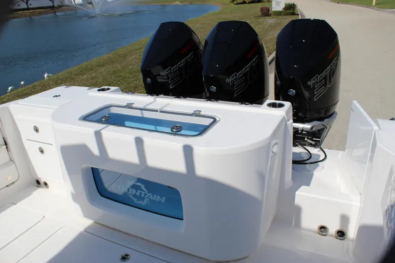  Yacht Photos Pics 2024 Fountain 32 NX boat with triple outboard engines, rear view.