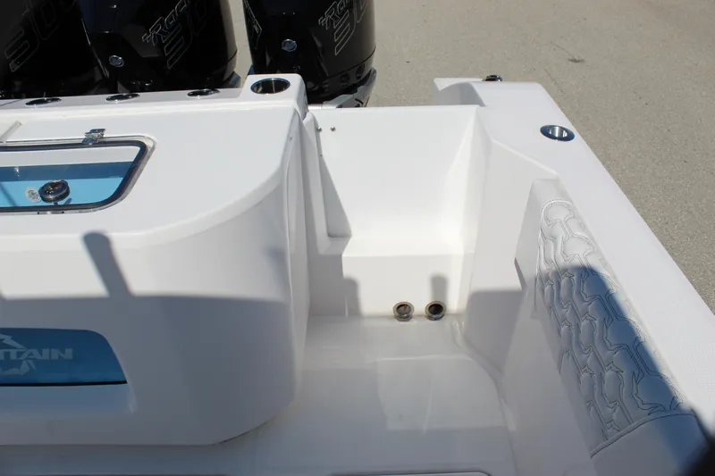  Yacht Photos Pics 2024 Fountain 32 NX boat interior with seating and engine area.