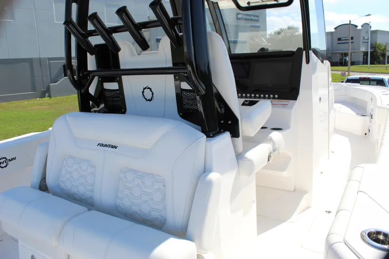  Yacht Photos Pics 2024 Fountain 32 NX boat interior with white seating and black rod holders.