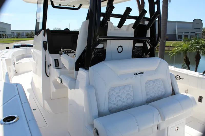  Yacht Photos Pics 2024 Fountain 32 NX boat interior with white seating and modern helm design.
