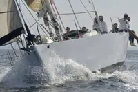 Sailing yacht Cape Codder Coder Withbread 57, 1985, cutting through waves with crew on deck.