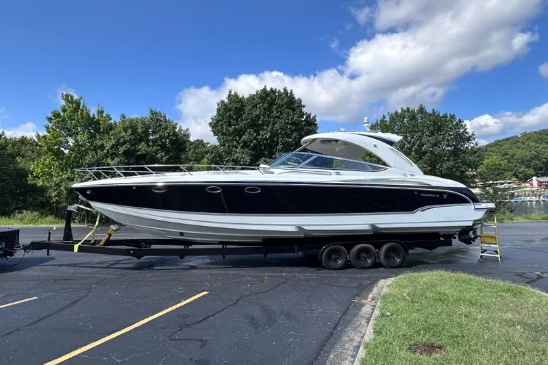  Yacht Photos Pics 2008 Formula 400 Super Sport boat on trailer, parked outdoors under blue sky.