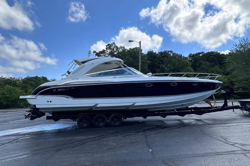  Yacht Photos Pics 2008 Formula 400 Super Sport boat on trailer, parked outdoors under a blue sky.