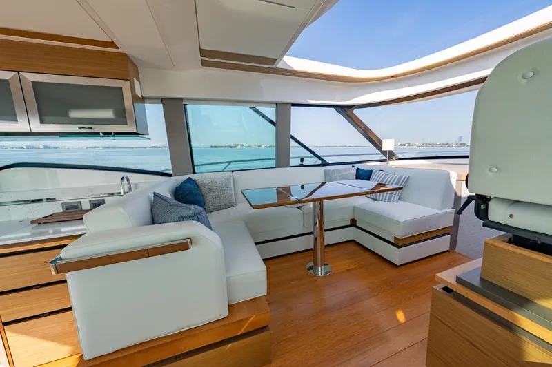 Bacchus Yacht Photos Pics Luxurious interior of 2022 Tiara Yachts Coupe with elegant seating and panoramic windows.