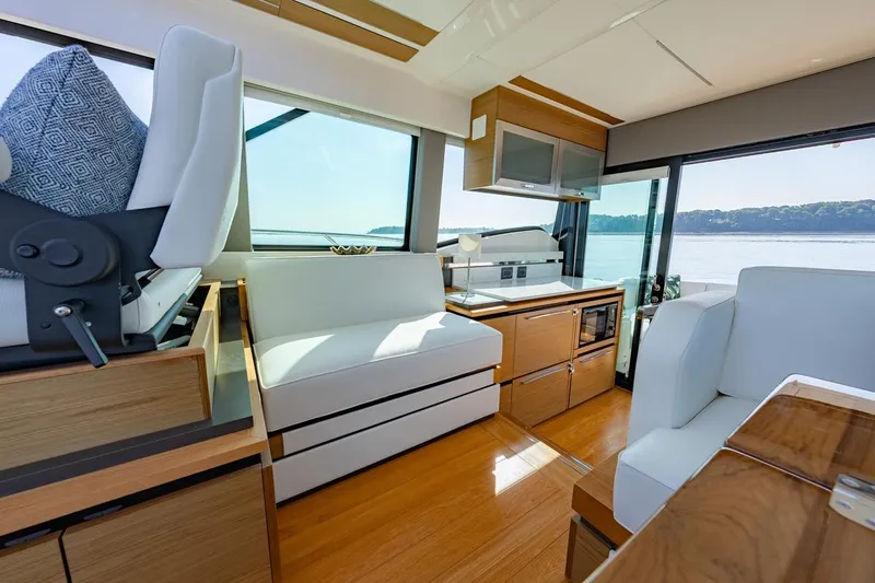 Bacchus Yacht Photos Pics Luxurious interior of 2022 Tiara Yachts Coupe with modern furnishings and scenic water view.