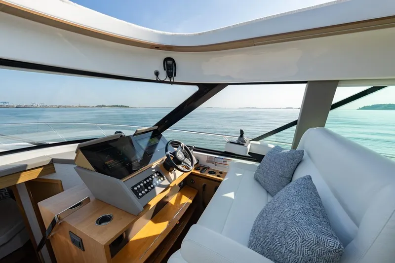 Bacchus Yacht Photos Pics Interior of 2022 Tiara Yachts Coupe, featuring modern helm and luxurious seating.