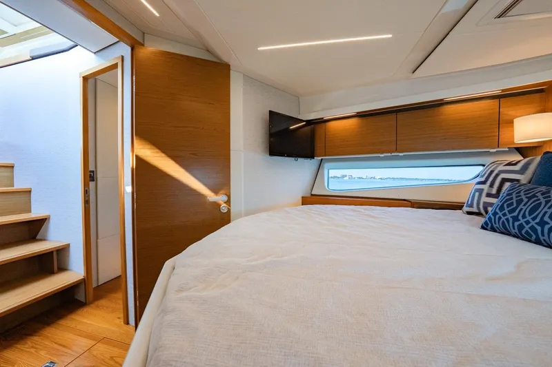 Bacchus Yacht Photos Pics Luxurious 2022 Tiara Yachts Coupe interior with cozy bedroom and scenic window view.
