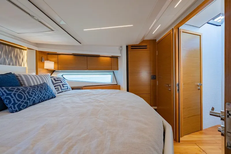 Bacchus Yacht Photos Pics Luxurious 2022 Tiara Yachts Coupe bedroom with modern design and elegant wood finishes.