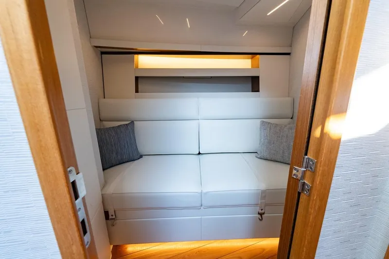 Bacchus Yacht Photos Pics 2022 Tiara Yachts Coupe interior with white seating and wooden accents.