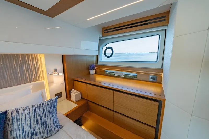 Bacchus Yacht Photos Pics Luxurious interior of 2022 Tiara Yachts Coupe with elegant wood finish and ocean view.