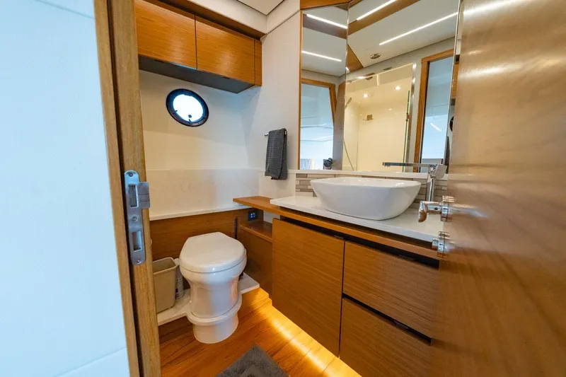 Bacchus Yacht Photos Pics Luxurious bathroom in 2022 Tiara Yachts Coupe, featuring modern fixtures and wooden cabinetry.