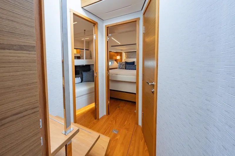 Bacchus Yacht Photos Pics Luxurious interior of 2022 Tiara Yachts Coupe, featuring elegant wood finishes and cozy cabins.