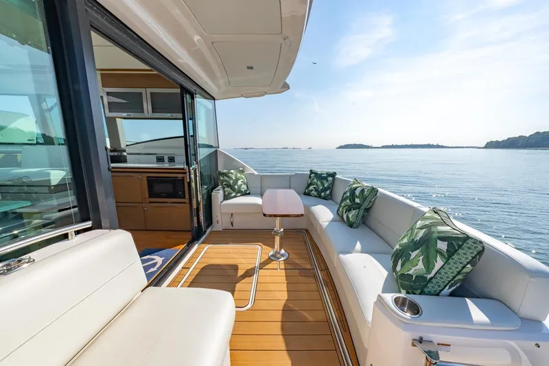 Bacchus Yacht Photos Pics Luxurious 2022 Tiara Yachts Coupe with elegant seating and ocean view.