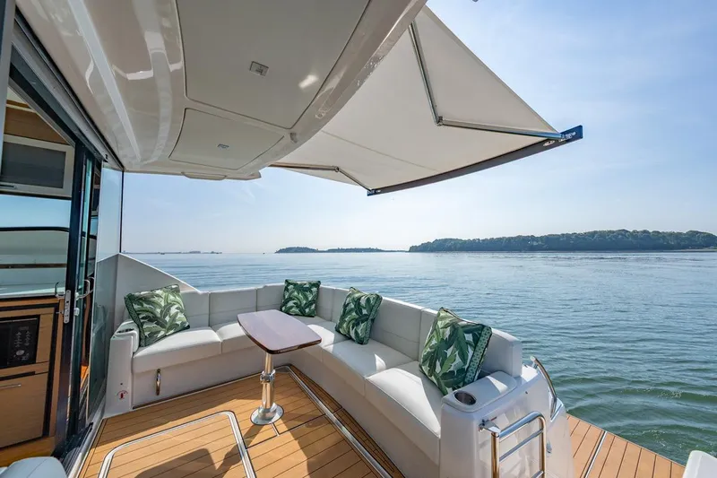 Bacchus Yacht Photos Pics Luxurious 2022 Tiara Yachts Coupe with elegant seating and scenic ocean view.