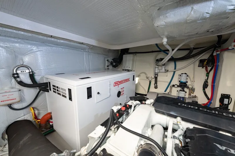Bacchus Yacht Photos Pics Engine room of 2022 Tiara Yachts Coupe with Westerbeke generator and modern equipment.