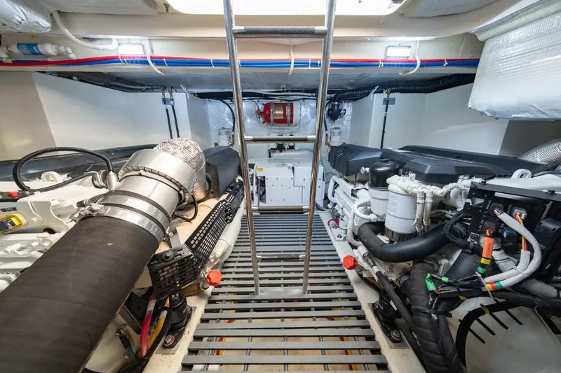 Bacchus Yacht Photos Pics Engine room of 2022 Tiara Yachts Coupe, featuring dual engines and ladder access.