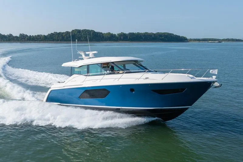 Bacchus Yacht Photos Pics 2022 Tiara Yachts Coupe cruising on open water, showcasing sleek design and performance.