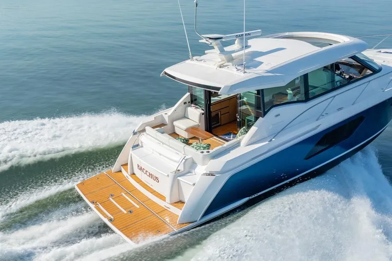 Bacchus Yacht Photos Pics 2022 Tiara Yachts Coupe cruising on water, showcasing sleek design and luxury features.