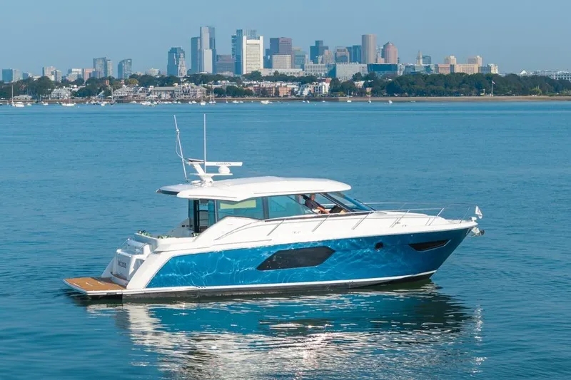 Bacchus Yacht Photos Pics 2022 Tiara Yachts Coupe on water with city skyline backdrop.