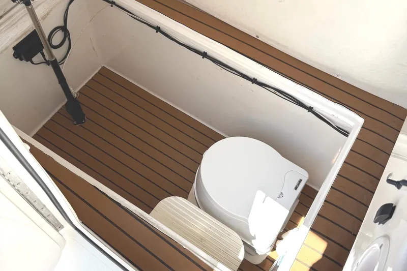 Huntress Yacht Photos Pics 2007 SeaHunter 40 boat interior with wooden flooring and compact toilet.
