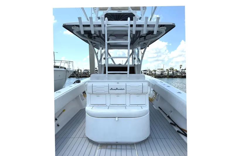 Huntress Yacht Photos Pics 2007 SeaHunter 40 boat interior with seating and rod holders, docked at marina.