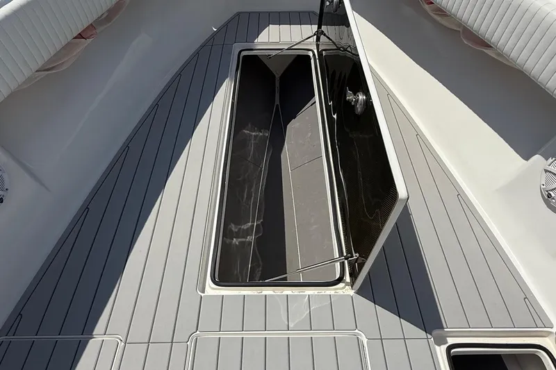 Huntress Yacht Photos Pics Open storage compartment on 2007 SeaHunter 40 boat deck with gray flooring.