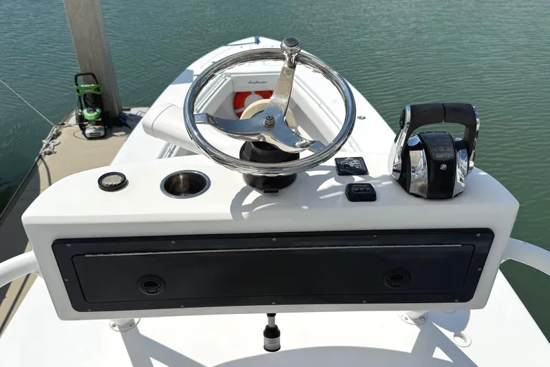 Huntress Yacht Photos Pics Steering console of a 2007 SeaHunter 40 boat, featuring a chrome wheel and controls.
