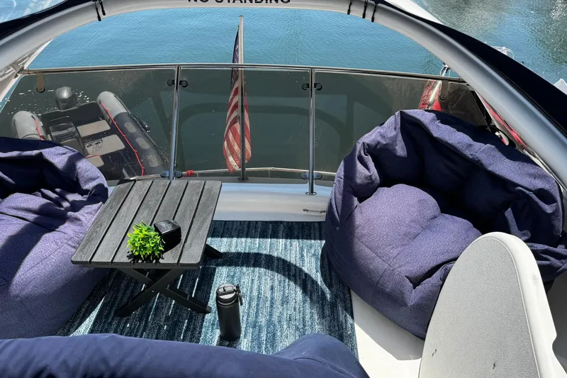 My Way Yacht Photos Pics Luxurious 2001 Fairline 55 yacht deck with bean bags, table, and water view.