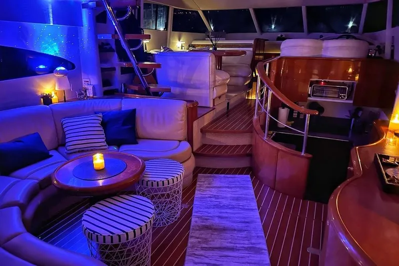 My Way Yacht Photos Pics Luxurious interior of a 2001 Fairline 55 yacht with ambient lighting and elegant seating.