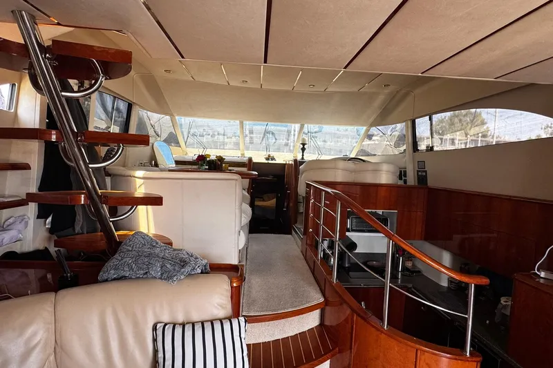 My Way Yacht Photos Pics Luxurious interior of a 2001 Fairline 55 yacht with elegant wood finishes and modern design.