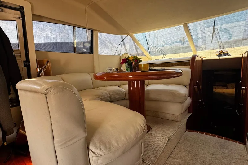 My Way Yacht Photos Pics Luxurious interior of 2001 Fairline 55 yacht with plush seating and wooden table.
