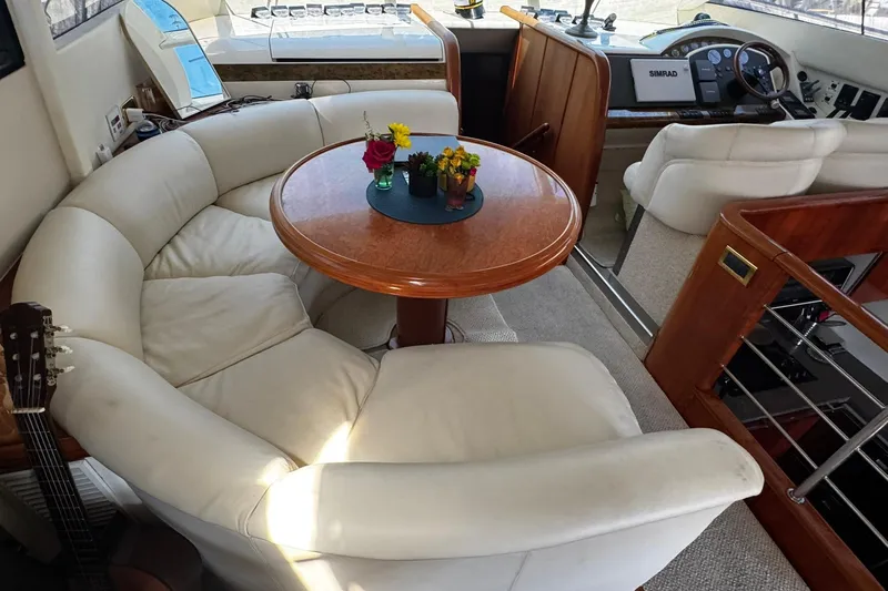 My Way Yacht Photos Pics Luxurious interior of 2001 Fairline 55 yacht with plush seating and elegant wooden table.