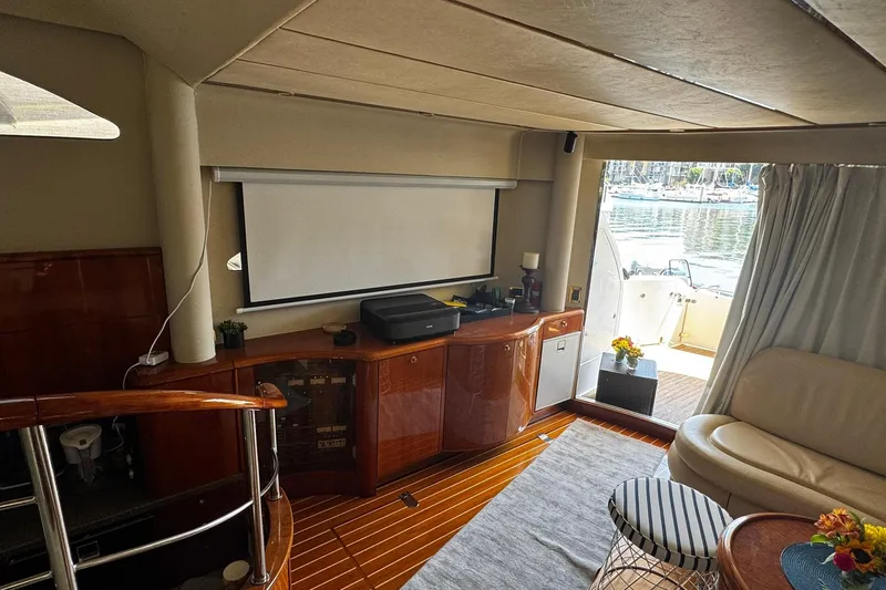 My Way Yacht Photos Pics Luxurious interior of 2001 Fairline 55 yacht with elegant wood finishes and cozy seating.