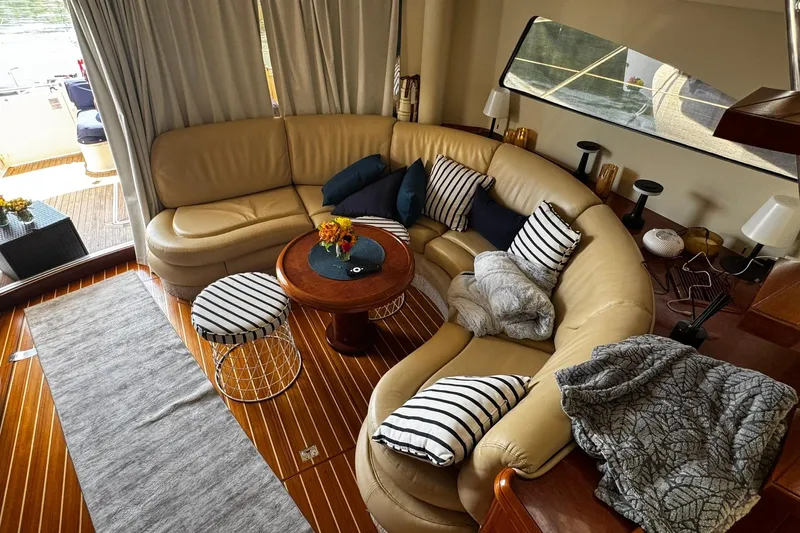 My Way Yacht Photos Pics Luxurious interior of 2001 Fairline 55 yacht with leather seating and striped cushions.