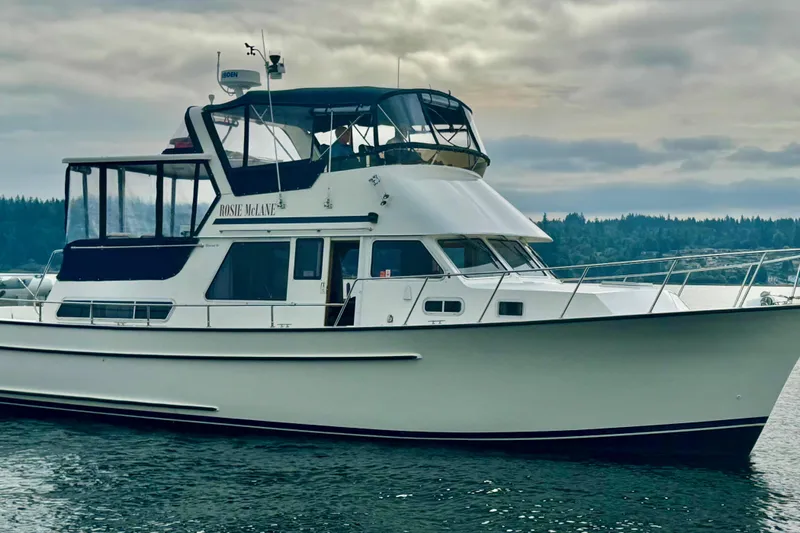 Rosie Mclane Yacht Photos Pics Luxury yacht on calm water, featuring a sleek design and spacious upper deck.