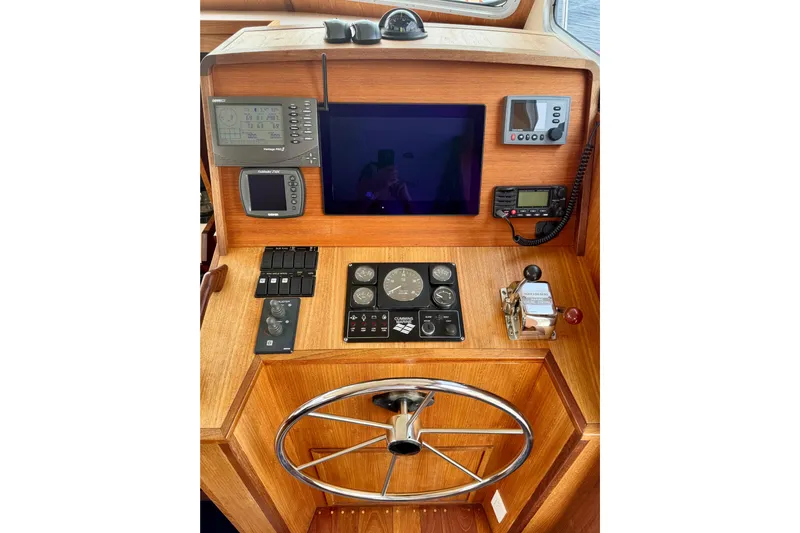 Rosie Mclane Yacht Photos Pics Wooden boat helm with navigation instruments, steering wheel, and control panel. Westcoast Sedan 2006.