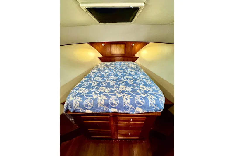 Rosie Mclane Yacht Photos Pics Cozy cabin interior with nautical-themed bedding in a 2006 Westcoast Sedan.