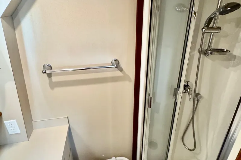 Rosie Mclane Yacht Photos Pics Modern bathroom with glass shower, chrome fixtures, and towel rack in a 2006 Westcoast Sedan.