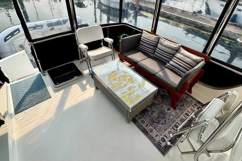 Rosie Mclane Yacht Photos Pics Boat interior with seating, nautical map table, and striped cushions, Westcoast Sedan 2006.