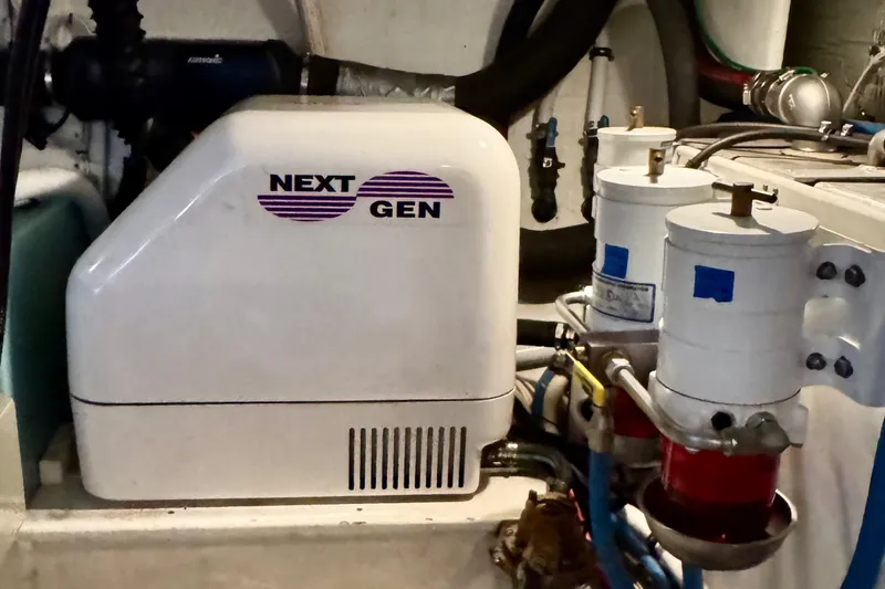 Rosie Mclane Yacht Photos Pics Next Gen generator in 2006 Westcoast Sedan engine room, featuring fuel filters and hoses.